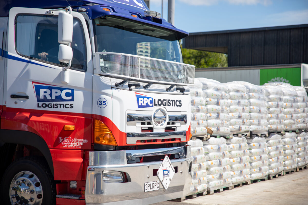 RPC Logistics truck beside palletised FMCG goods ready for delivery