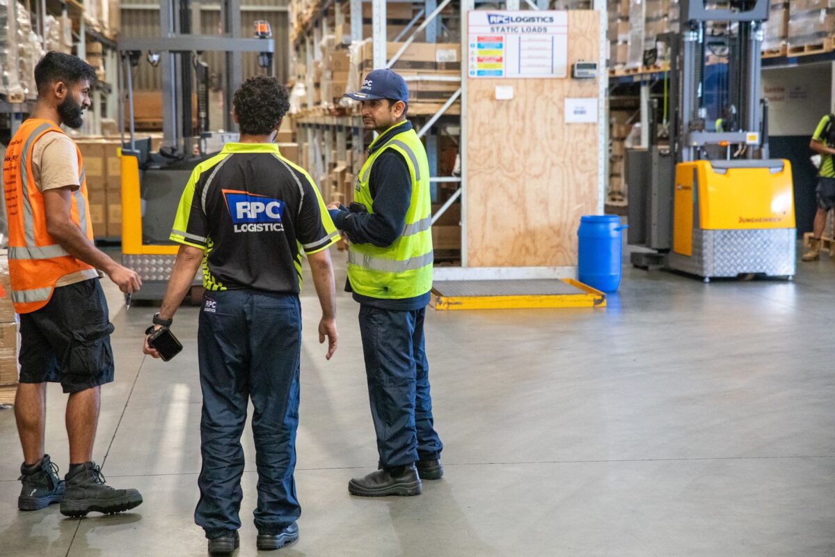 RPC Logistics warehouse team planning work in the racking aisle